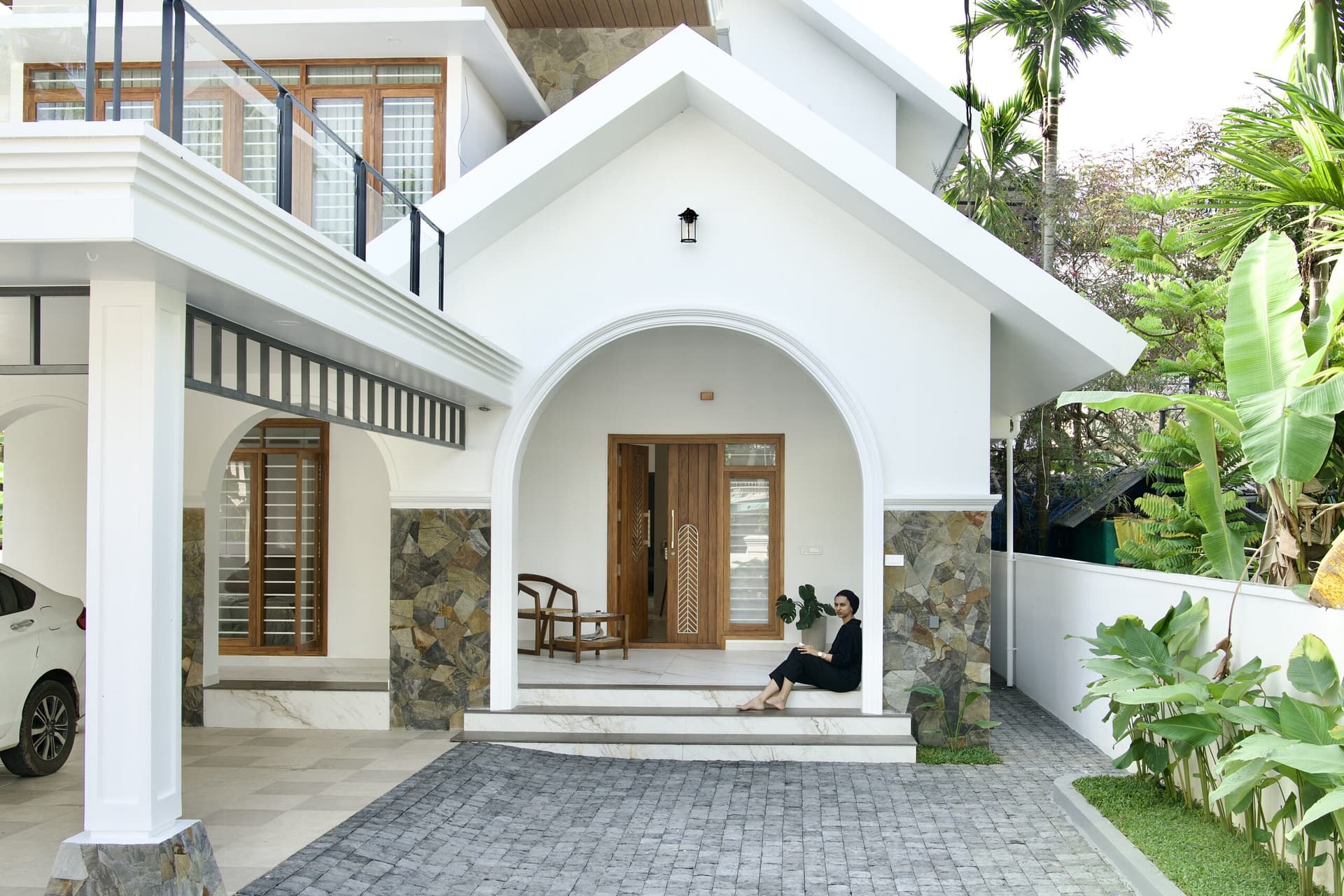 Image of a colonial inspired house with elements like arches.